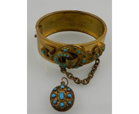 An unusual Victorian gilt metal and turquoise bangle with buckle decoration, together with a yellow metal Momento Mori pendan