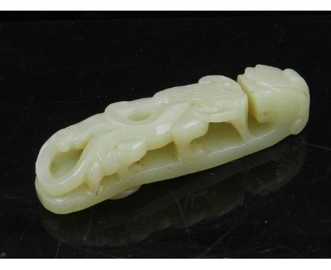 A Chinese jade buckle, fashioned as a mythical creature. W.10cm