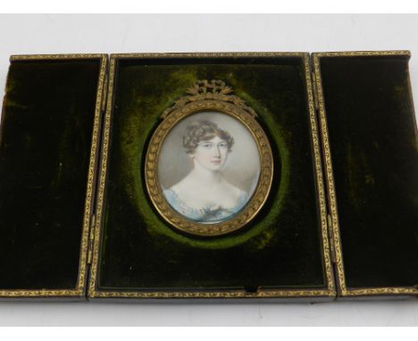 19th century Continental school, a portrait miniature of a finely dressed lady, oil on ivory, fitted within a brown velvet an