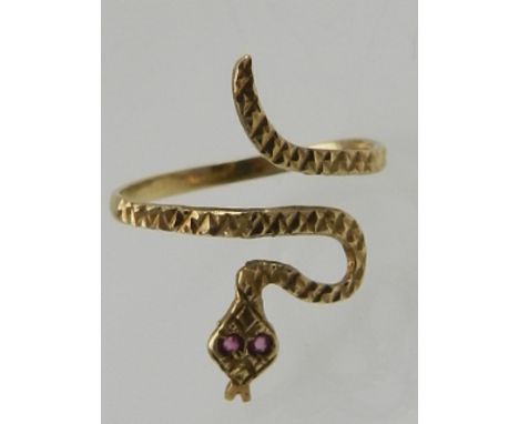 An unusual 9 carat yellow gold and ruby ring in the form of a snake. 