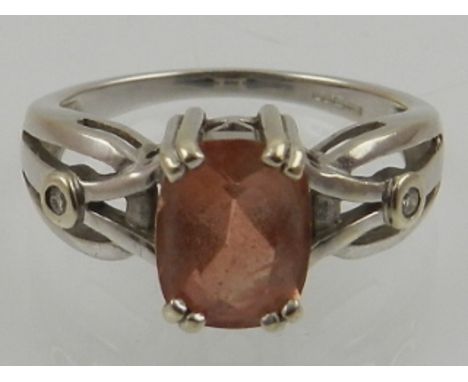 An unusual 9 carat white gold, diamond, and Tibetan sunstone ring.