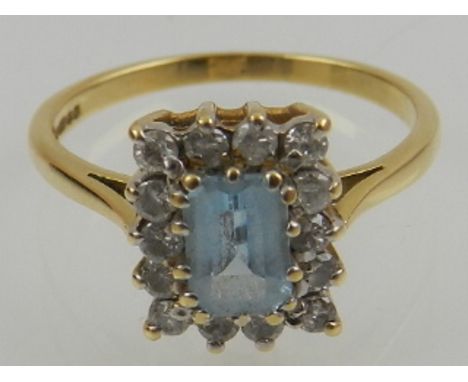 An 18 carat yellow gold, diamond, and aquamarine cluster ring. 