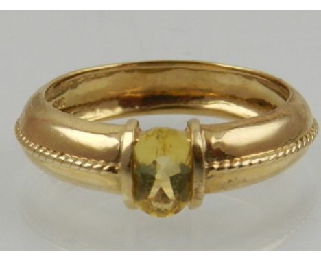 A 9 carat yellow gold and oval cut citrine ring. 