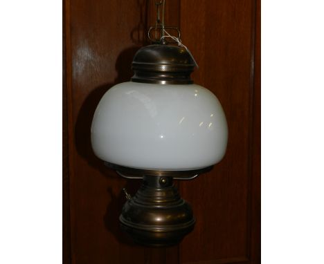 A brass mounted glass ceiling light, of globular form. 