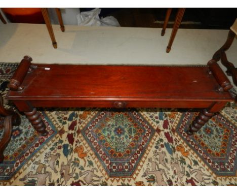 A William IV mahogany window stool, raised on turned bobbin supports and bun feet. H.46cm W.105cm