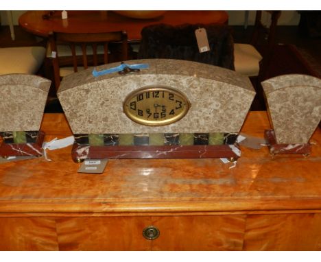 An Art Deco marble clock and garniture, the dial with Roman numerals, having eight day movement, striking bell. 