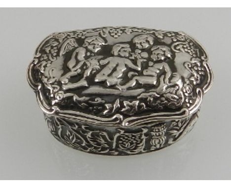 A novelty silver trinket box, repousse decorated with cherubs. 