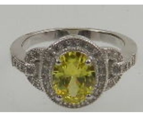 A silver and white and yellow cubic zirconia set cluster cocktail ring. 