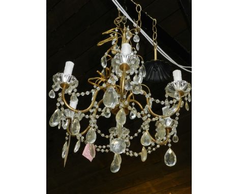 A mid 20th century gilt metal chandelier, having cut glass droplets.