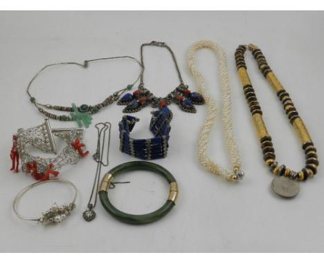 A quantity of costume jewellery, to include a jade bangle, a white metal choker, various necklaces etc. 