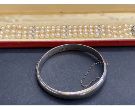 Silver bangle together with costume jewellery pearl necklace 