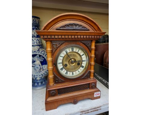 An H.A.C. walnut mantel clock, labelled to interior, 36cm high, with pendulum. 