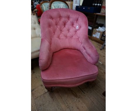 A Victorian walnut and button upholstered occasional chair. 