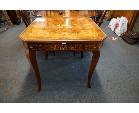 An Italian walnut and marquetry games table,&nbsp;incorporating backgammon and chequerboards and further opening to reveal a 