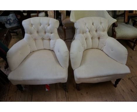 A pair of late Victorian walnut and button upholstered salon tub chairs.&nbsp; 