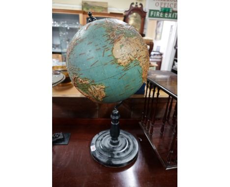 A Philips' 12 inch Relief Globe, on ebonized stand, (s.d.). 