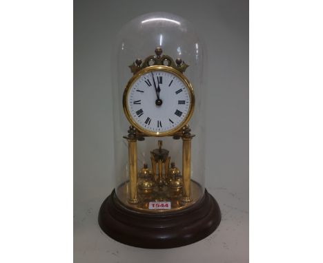A brass anniversary clock,&nbsp;with enamel dial and glass dome, total height 30cm.&nbsp; 