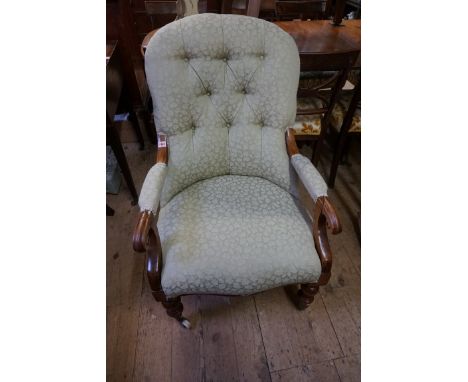 A Victorian walnut and button upholstered open arm occasional chair. 