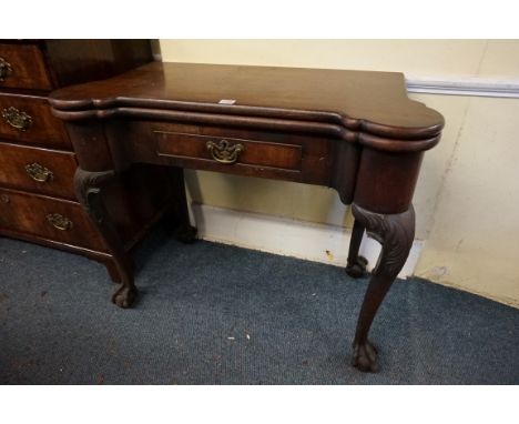An 18th century 'red walnut' card table, possibly Irish,&nbsp;the foldover top with dished outset corners above a frieze draw