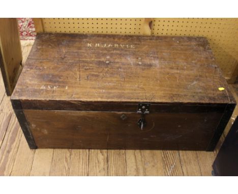 An early 20th century hardwood oblong travelling trunk with fitted interior with metal clasps and fittings