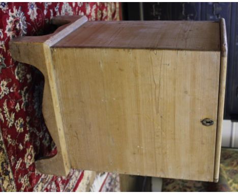 An antique pine fireside seat or storage box with lift up seat, flush brass handle and escutcheon, raised on bracket feet, 51