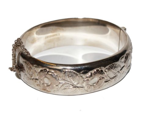 A silver bangle decorated in relief and a plated vesta case