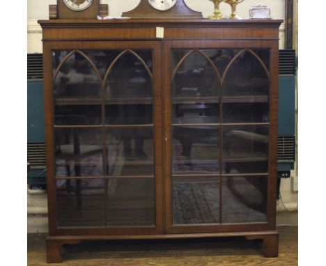 A Georgian-style mahogany floor display cabinet with plain frieze, astragal doors, shelved interior raised on bracket feet, 1