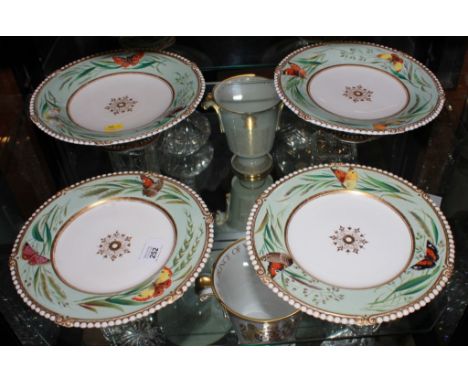 A pair of Minton-style circular ceramic plates and two comports with floral and foliate and butterfly hand painted depictions