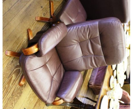 A 'Chairman' Mobel Team (Sweden) leather swivel reclining chair and foot stool with stained hardwood frame and supports 