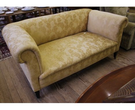 A 19th century-style fabric upholstered Chesterfield three seater sofa with adjustable arm rest, raised on square tapering le