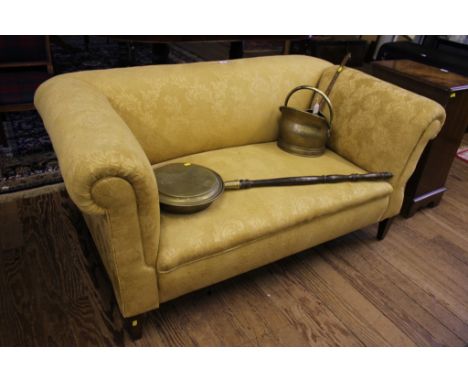 A 19th century-style Chesterfield two-seater sofa with fabric upholstery, adjustable arm rest, raised on square tapering legs