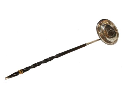 A Georgian silver punch ladle with whalebone handle and coin to bowl