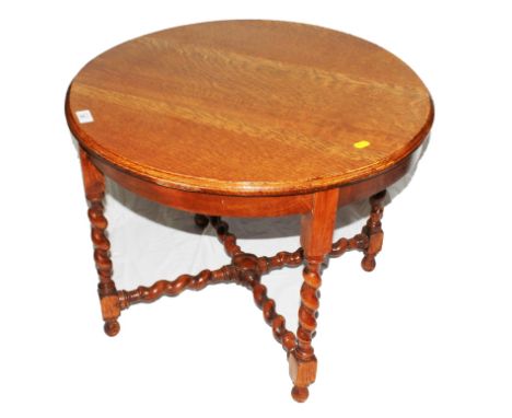 An early 20th century light oak circular occasional table with shaped top, rope twist supports and 'X' shaped stretcher, 46cm