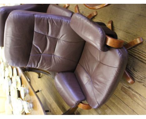 A 'Chairman' Mobel Team (Sweden) leather swivel reclining chair and foot stool with stained hardwood frame and supports 