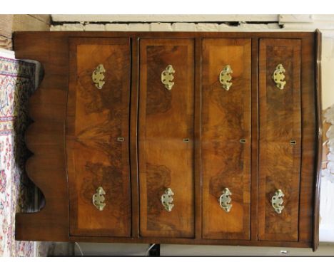 A Georgian-style mahogany and cross banded serpentine fronted chest of four graduated drawers, shaped top, brass dropped hand