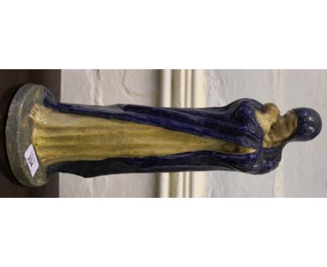 A painted ceramic figurine of Madonna and child in a long cream dress and blue cloak, circular plinth with indistinct signatu