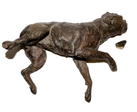 A ceramic figurine of a recumbent dog, 32cm long