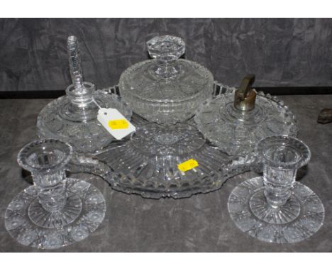 An assortment of mid-20th century crystal glass dressing table utensils comprising of powder bowl, candle stick, tray, paraff