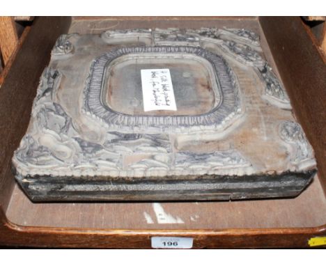 A wooden printing block with steel insets depicting greyhounds around a bordered central panel, 29cm square