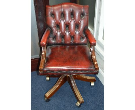 A BURGUNDY BUTTON BACK SWIVEL OFFICE/STUDY CHAIR, on a mahogany frame