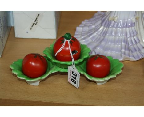 A CARLTONWARE NOVELTY CRUET SET AND STAND, shaped as tomatoes in leaves