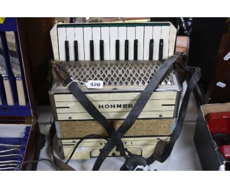 A HOHNER STUDENT 1 PICCOLLO PIANO ACCORDIAN, 22 key 8 button configuration, finished in cream pearloid case and two leather s
