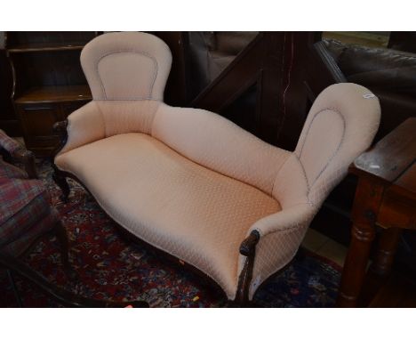 A VICTORIAN WALNUT FRAMED UPHOLSTERED SOFA, with carved foliate detail and scrolled feet