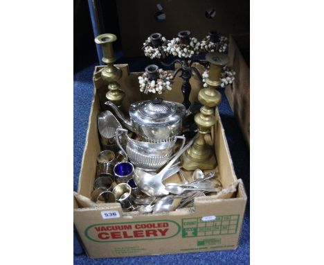 A BOX OF SILVER PLATE, including a three piece tea set, pair of brass candlesticks, soup ladle, etc