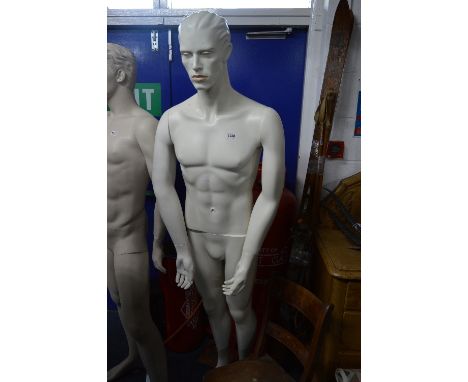 A FULL LENGTH MALE SHOP DISPLAY MANNEQUIN, on a seperate glass stand, approximate height 185cm