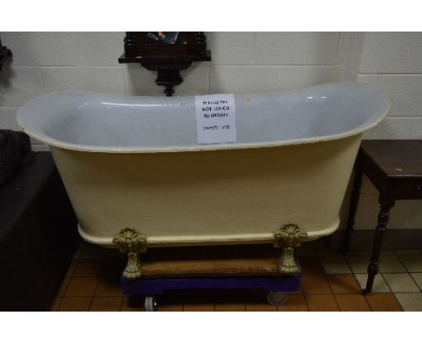 A VICTORIAN CAST IRON DOUBLE ENDED ROLL TOP BATH, white enamel interior, on four short cabriole legs with paw feet and free s