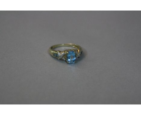 A 9CT BLUE STONE RING SET WITH DIAMONDS, ring size M, approximate weight 2.9 grams