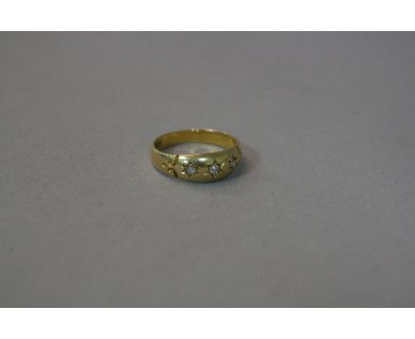 AN 18CT THREE STONE DIAMOND SET GYPSY RING, ring size N, approximate weight 3.3 grams