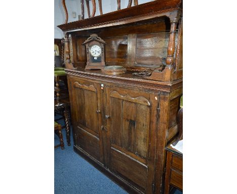 A 17TH CENTURY AND LATER OAK COURT CUPBOARD, the upper section has an open shelf above a large double panelled doors, approxi