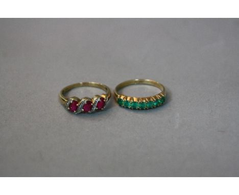 A 9CT SEVEN STONE EMERALD RING, ring size Q, approximate weight 2.2 grams, together with a 9ct ruby and diamond ring, ring si